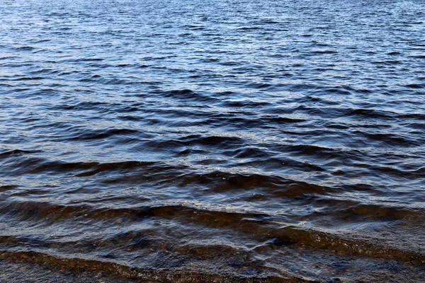 Close up of beautiful water surfaces of a lake on a windy day