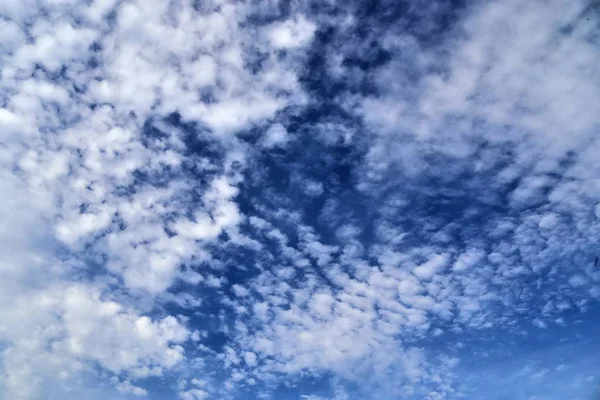 在深蓝色的天空中美丽的蓬松白云 — 图库照片