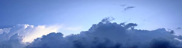 Detailed high resolution panorama of dramatic clouds in the sky with sunlight coming through the clouds