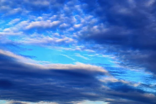 Stunning mixed cloud formation panorama on a deep blue summer sky