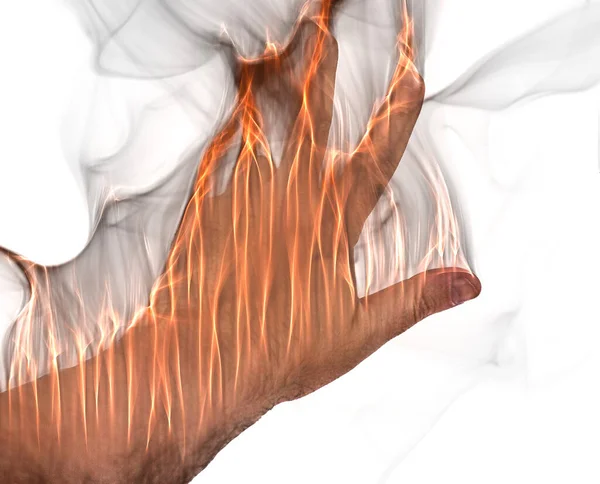 A human hand on fire burning with orange flames and some smoke in front of a white background