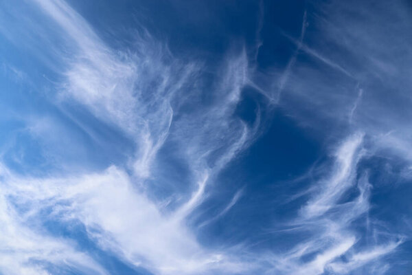 Stunning cirrus cloud formation panorama in a deep blue summer sky seen over Europe