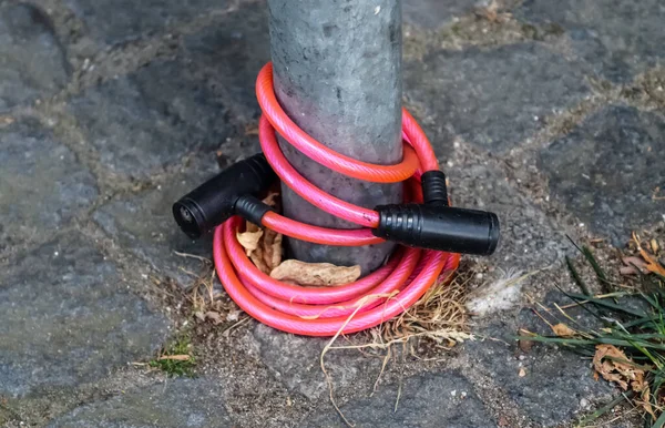 Abandoned bike lock left at a metallic fence. Bike stolen.