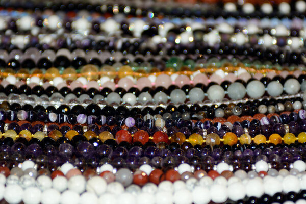 multi-colored onyx necklace lie on the counter. The concept is the production of onyx products. Semiprecious stones