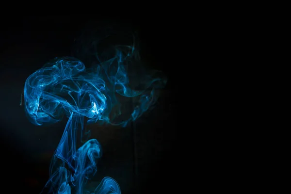 Colored smoke isolated on black background in the form of brain