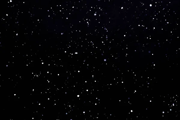 Caduta neve su sfondo nero Fiocchi di neve Volare in aria . Immagini Stock Royalty Free