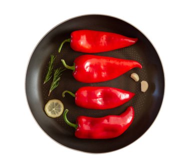 Biberiye sprigs, limon dilimleri ve beyaz arka plan üzerinde sarımsak ile bütün kırmızı tatlı biber ile izole tava. ızgara biber pişirmek için malzemeler