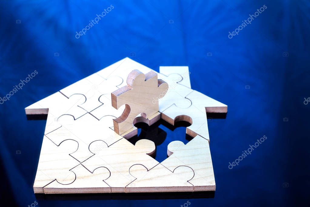 Wooden puzzle wait to fulfill home shape for build dream home or happy life concept  for property, mortgage and real estate investment.  for saving or investment for a house, retirement.jigsaw,