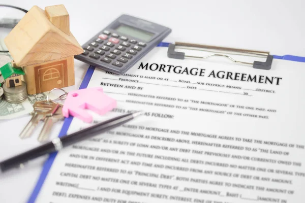 Approved Mortgage loan application with house key and finalizing