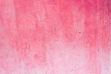 Pembe beton duvar. Vinyet biraz ile aşınmış soluk pembe beton duvar dokusu arka plan, boya kısmen soluk.