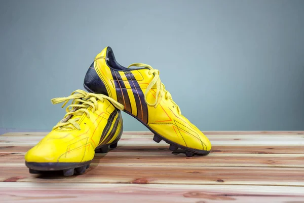 Old yellow football shoes