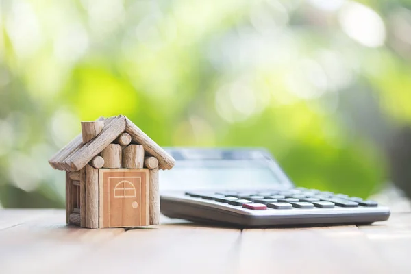 Het Huis Geplaatst Naast Rekenmachine Natuurlijke Wazig Groene Achtergrond Het — Stockfoto