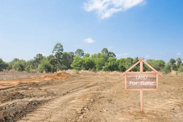 House symbol with location pin and Empty dry cracked swamp reclamation soil, land plot for housing construction project with and beautiful blue sky with fresh air Land for sales landscape concept