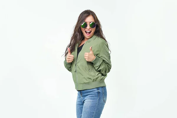 Happy excited woman smile holding thumbs up gesture, beautiful young woman smile looking at camera