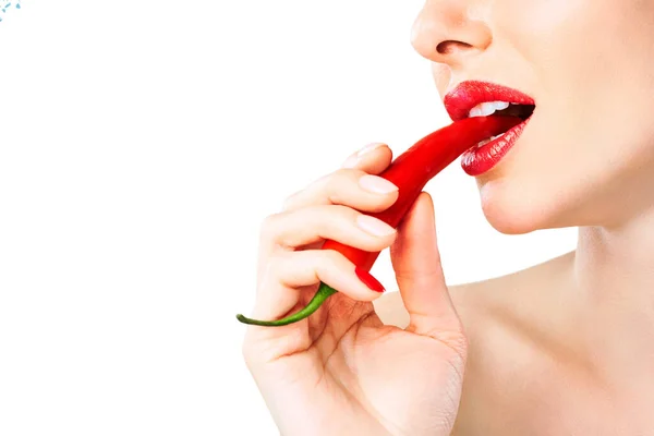 Mooie vrouw tanden eten van red hot chili peper — Stockfoto