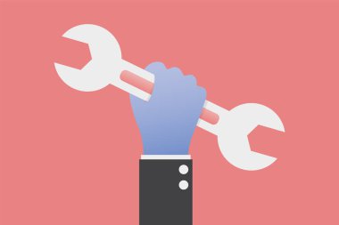 bir İngiliz anahtarı tutan el.