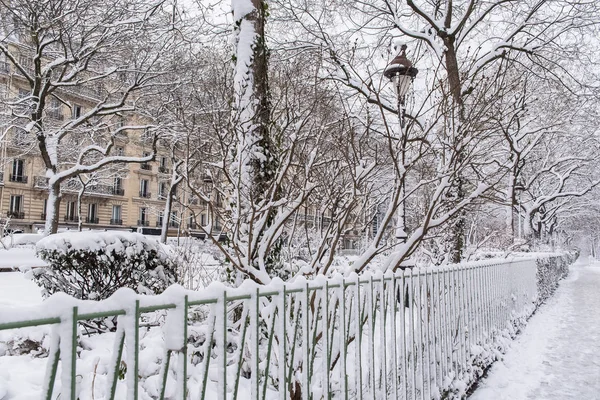 Paris under the snow, beautiful building facades in winter