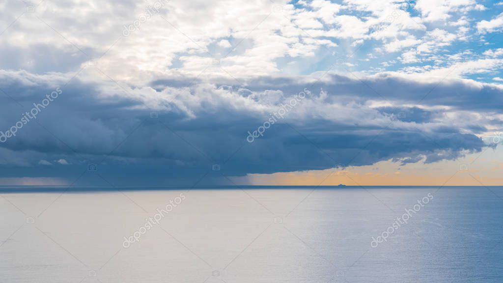The Mediterranean Sea, bay of Nice, panorama of a storm and a ship in background