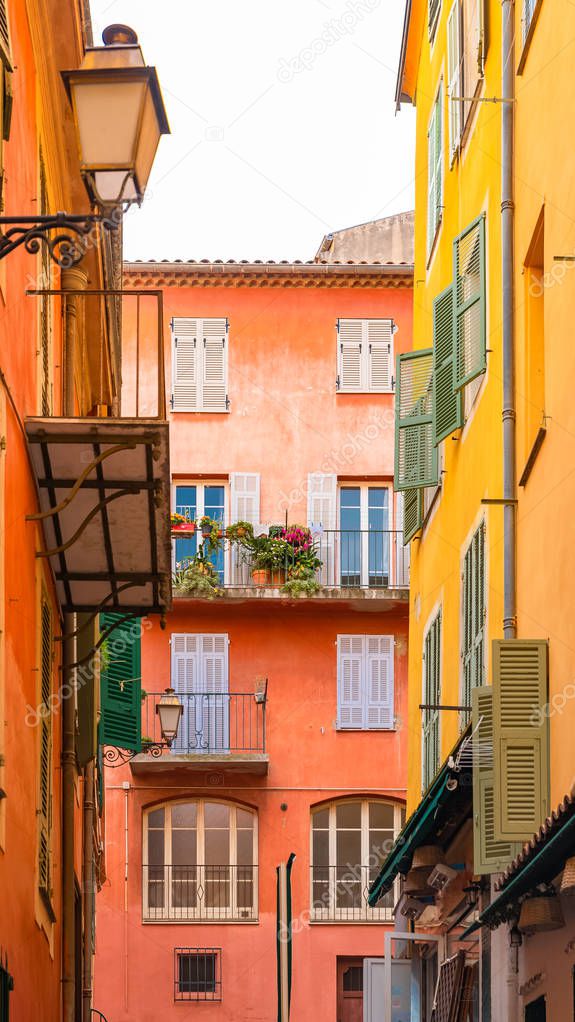 Nice, France, colorful facade, with typical windows, balconies and shutters 