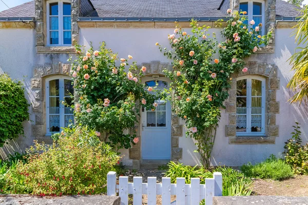 Beautiful small house in Brittany, typical home with rosebush and a wooden gate