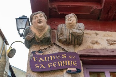 Vannes, France, May 21st, 2019, statues of Vannes and his wife on an old half-timbered red house, beautiful touristic town in Brittany  clipart