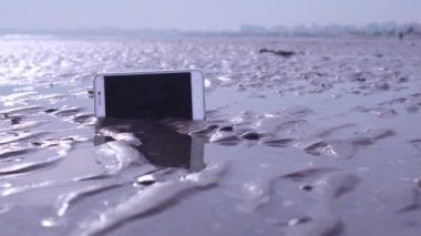 Plaj ıslak kum sıkışmış Smartphone