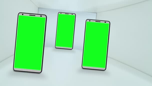 Drie smartphones met groene schermen voor de chroma sleutel — Stockvideo