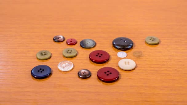 Sewing buttons of different colors in stop motion — Stock Video