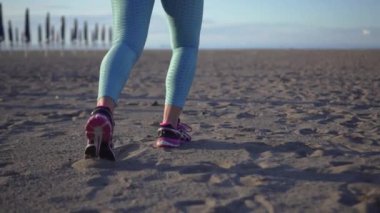 Kız sabah kumsalda koşuyor.