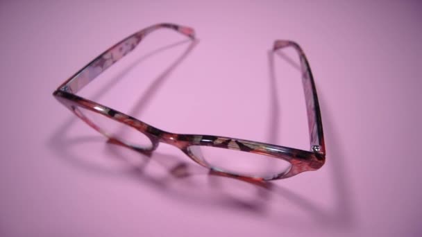 Motion along elegant women glasses with bright pattern rim — Stock Video