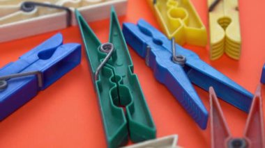 Kırmızı arkaplanda giysi iğneleri üzerinde yakın hareket