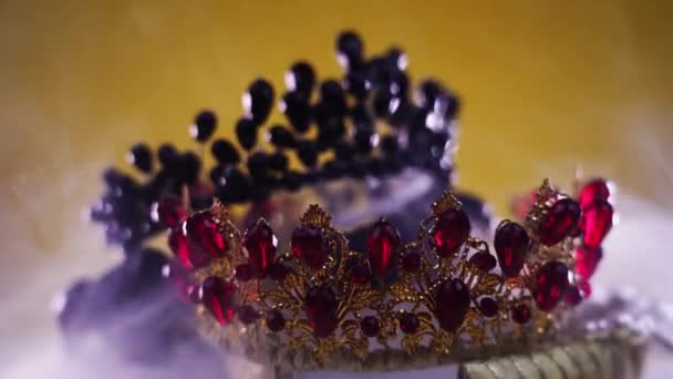 Stack of tiaras decorated with gemstones in steam cloud — Stock Video