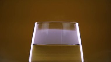 Hardal renginde bardakta temiz suyun üzerinde beyaz buhar.