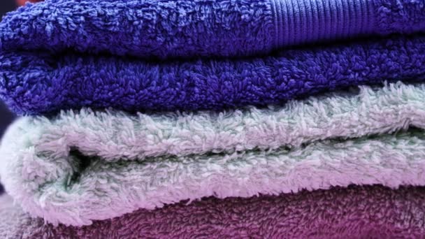 Pila de toallas de rizo azul gris y púrpura gira en el estudio — Vídeos de Stock