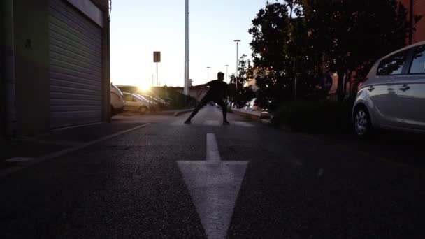 Dancer silhouette performs on zebra crossing at sunset — Stock Video