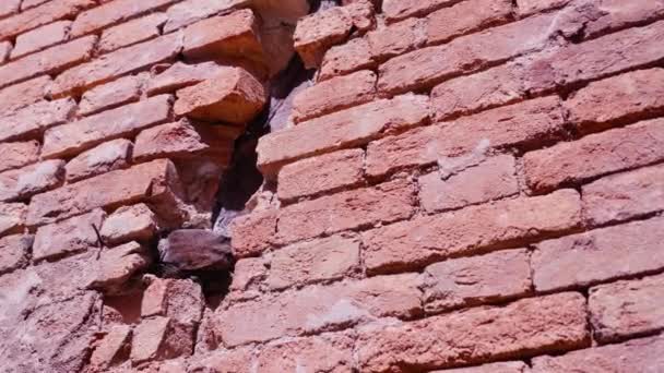 Facade of abandoned building made of red bricks with hole — Stock Video