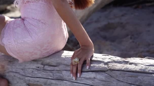 Langhaarige Dame legt Hand mit Maniküre und Ring auf Baumstamm — Stockvideo