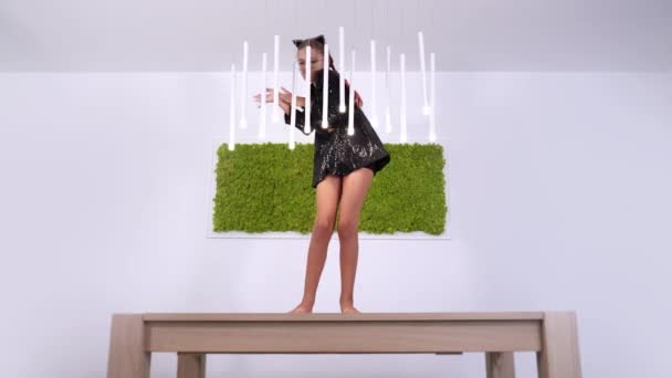 Adolescente danse jouer avec led lampes debout sur la table — Video