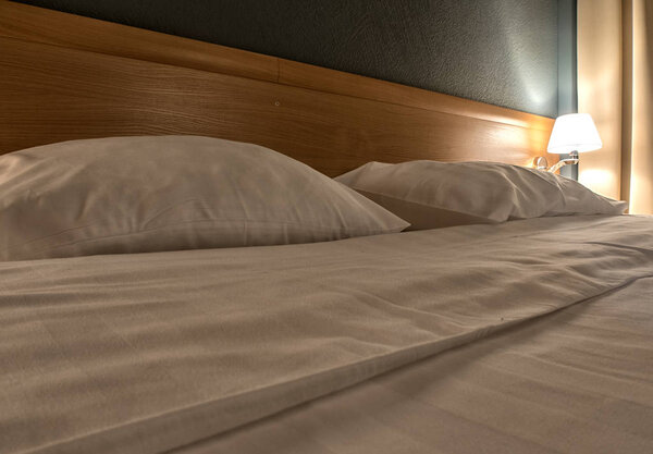 Top view of white bedding sheets and pillow.