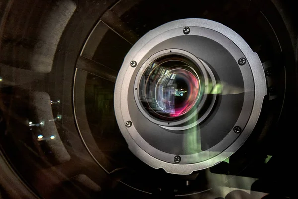 close up of a television lens on a dark background