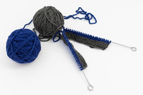 Balls of Wool with Knitting Needles
