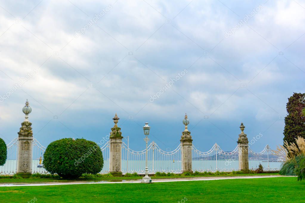 Beautiful garden of the Dolmabahce Palace in Istanbul, Turkey. Garden is full of trees, flowers, bushes.