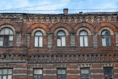 Gökyüzü arka planında pencereleri olan tuğla bina