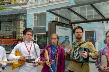 Moskova, Rusya - 9 Mayıs 2019: Akordeon balalayka çalan, geleneksel kostümlü kız şarkı söyleyen bir adam