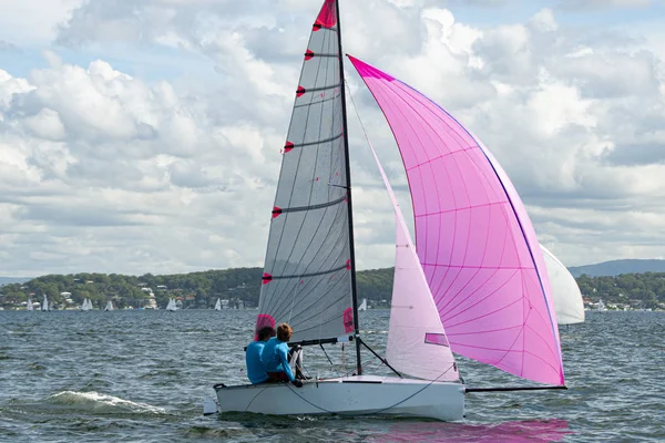 Two school kids sailing small sailboat with a fully deployed vib — Stock Photo, Image