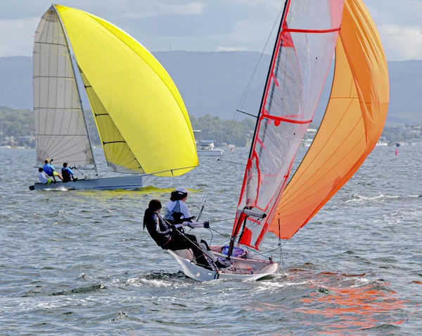 Barn seglar små segelbåtar med gula och orangea segel på — Stockfoto