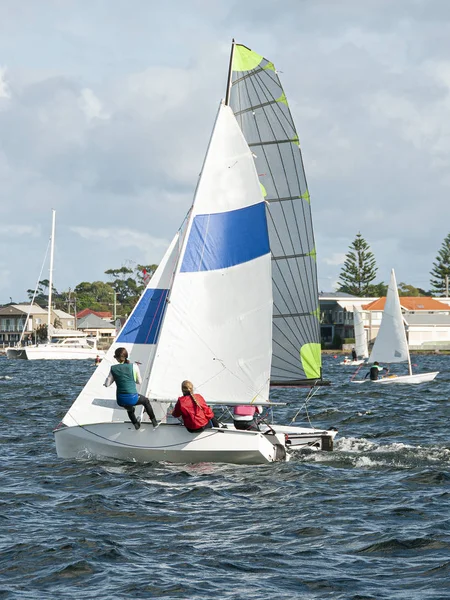 Children racing two sailboats close, side by side almost touchin — Stock Photo, Image