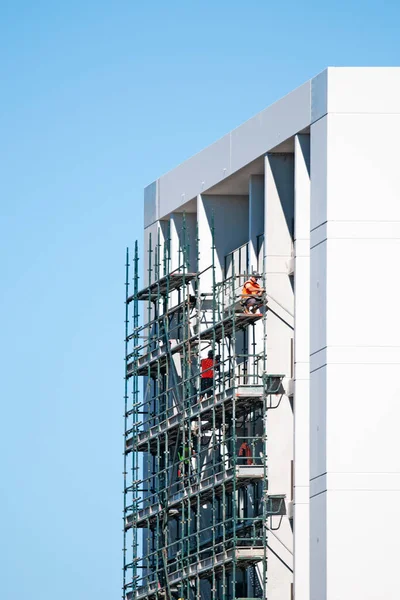 Building work series, progress on the new high rise apartments construction at 277 Mann St, Dismantling the scaffolding on the structure. External view. Commercial use image. Gosford, Australia - May 19 , 2020: