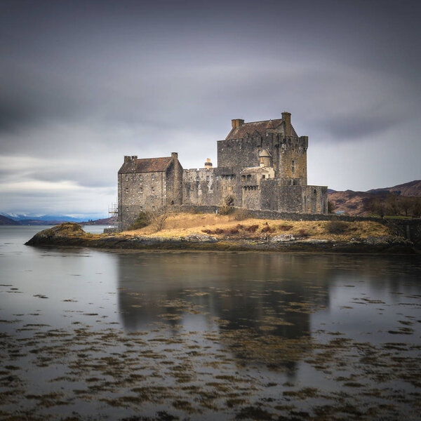 Eilean Donan castle on the shore of Loch Duich in cloudy day. Medieval castle in Scottish Highlands.