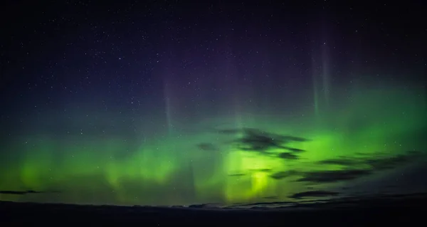 North lights Aurora Borealis seen from Atlantic Ocean Road - Atlanterhavsveien in winter night. Norwegian wintertime. Nice starry sky and green lights.